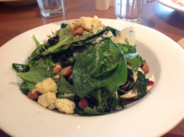 Delicious kale and spinach salad with beechers cheese, a local Seattle delicacy, sliced almonds, roast chicken breast and dried cranberries. 